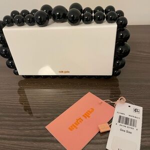 Cult Gaia Acrylic eos clutch with tags